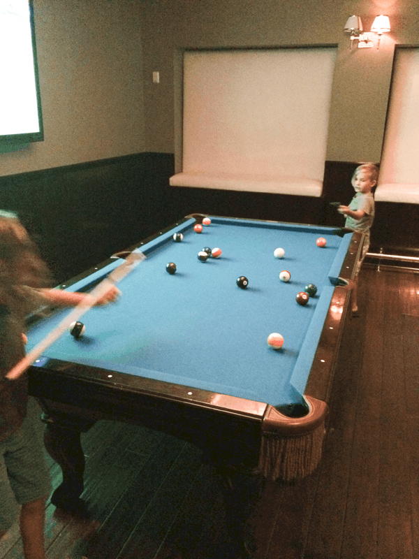 Boys playing pool at Rancho Las Palmas.