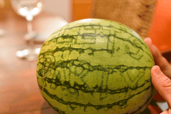A watermelon with words traced out in dots. 