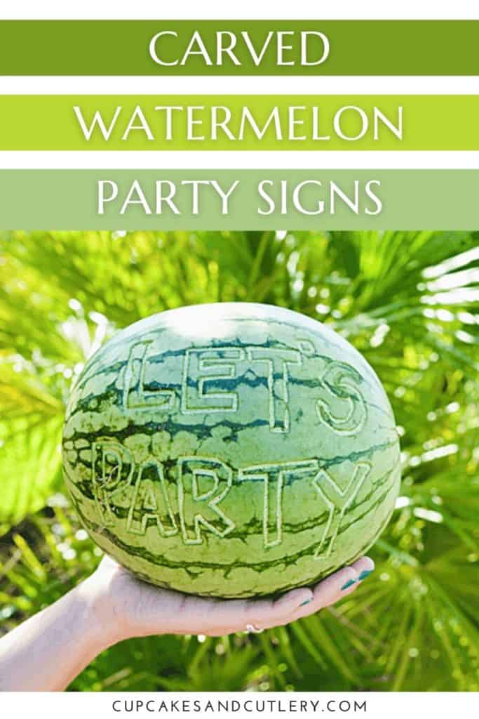 A carved watermelon being held by a woman's hand.