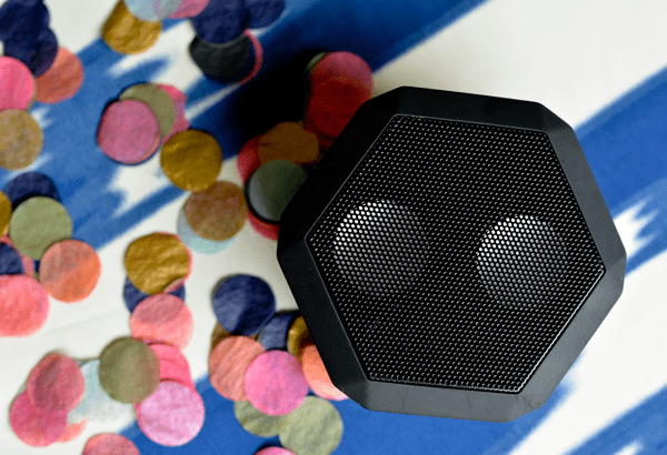 A portable speaker to play this Baby Shower Playlist on a table next to confetti. 