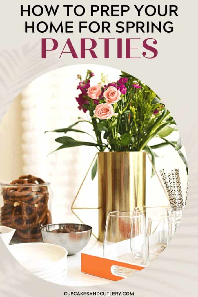 A spring party table with wine glasses, small plates and flowers.