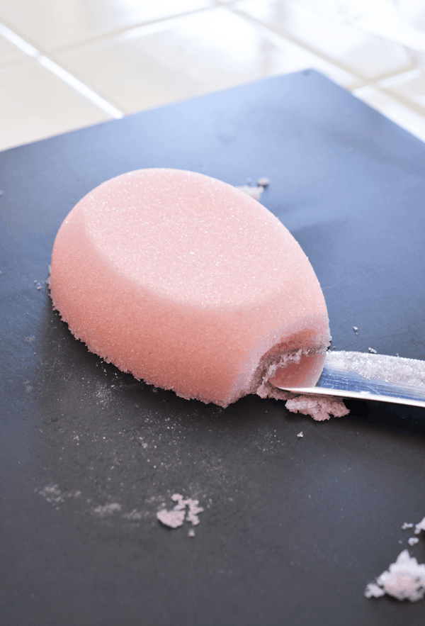 Pink sugar Easter egg and knife creating an opening.