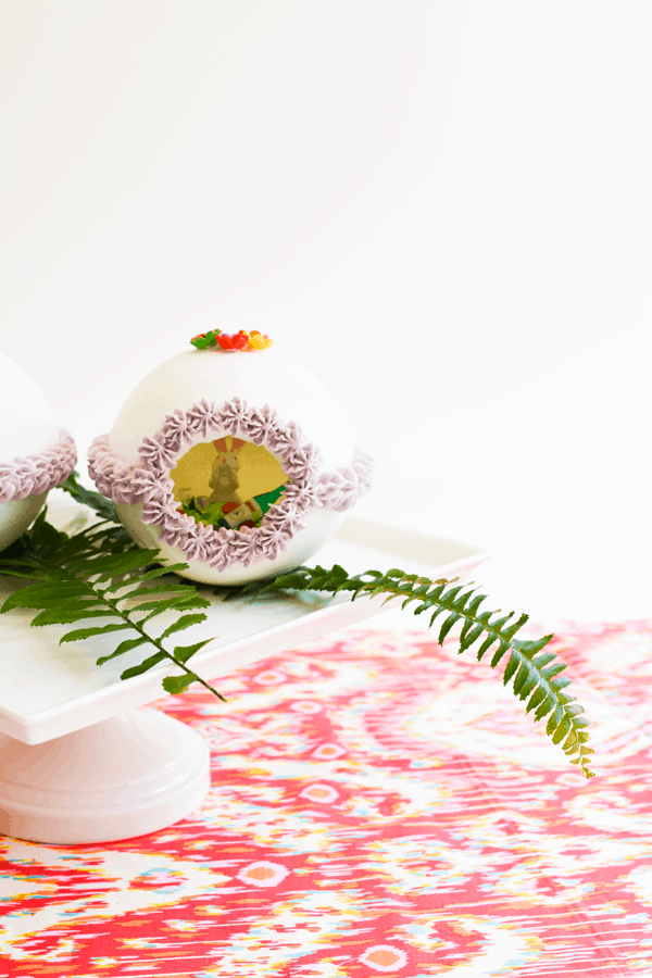 Decorated Sugar Easter Egg on a cake plate on a table.