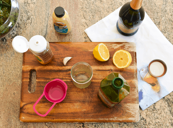 An overhead shot of a cutting board with a prosecco vinaigrette being made.