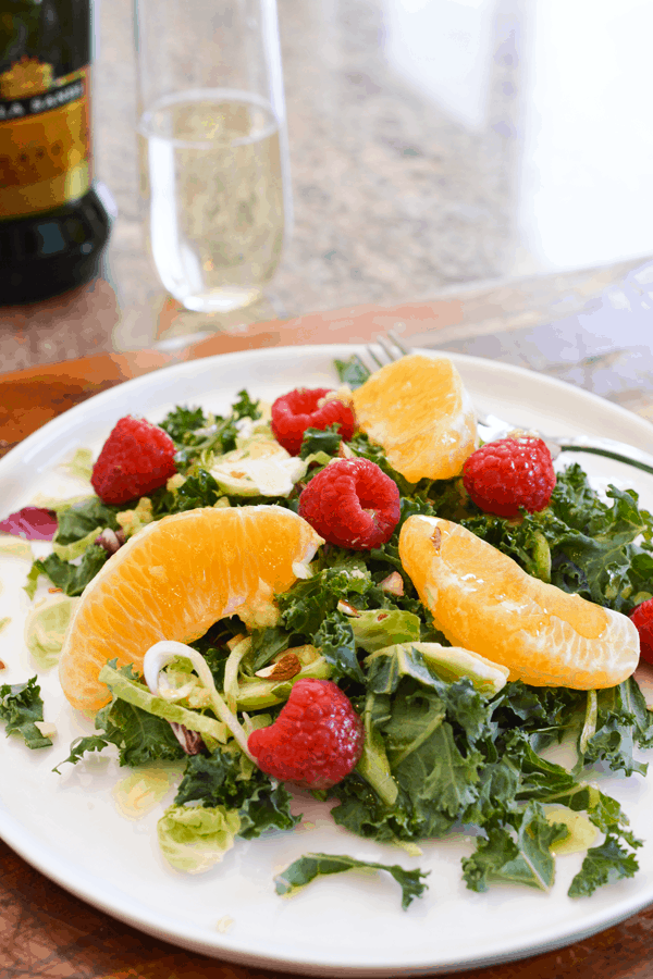 Kale salad with almonds, oranges and raspberries in a Prosecco vinaigrette.