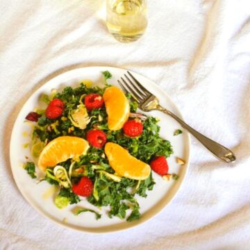 Brussels sprouts and kale salad topped with oranges, berries and prosecco vinaigrette dressing.
