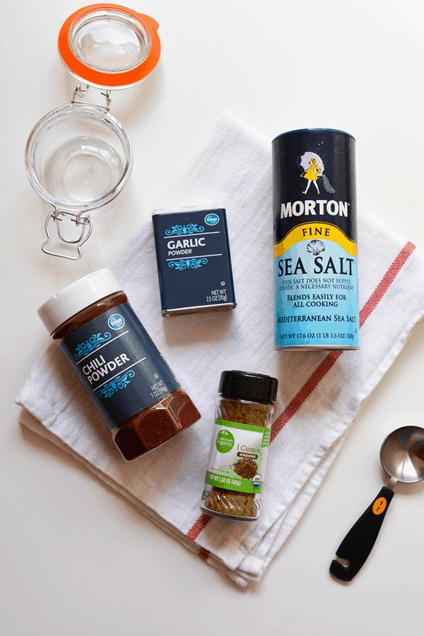 Ingredients for making homemade taco seasoning at home on a table. 