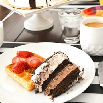 A slice of Cold Stone Ice Cream Cake on a waffle topped with strawberries for a Father's Day brunch.