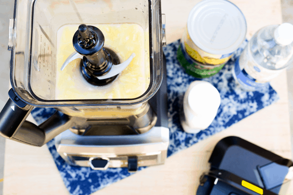Ingredients for a Pina Colada Slush measured into a blender before blitzing.