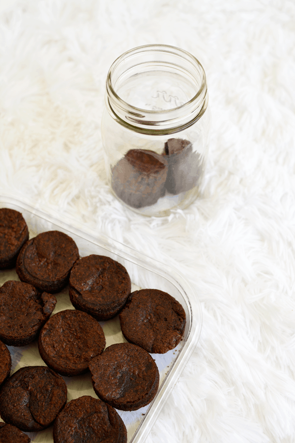 A box of store-bought brownies being put into a glass jar as a bad day gift idea. 