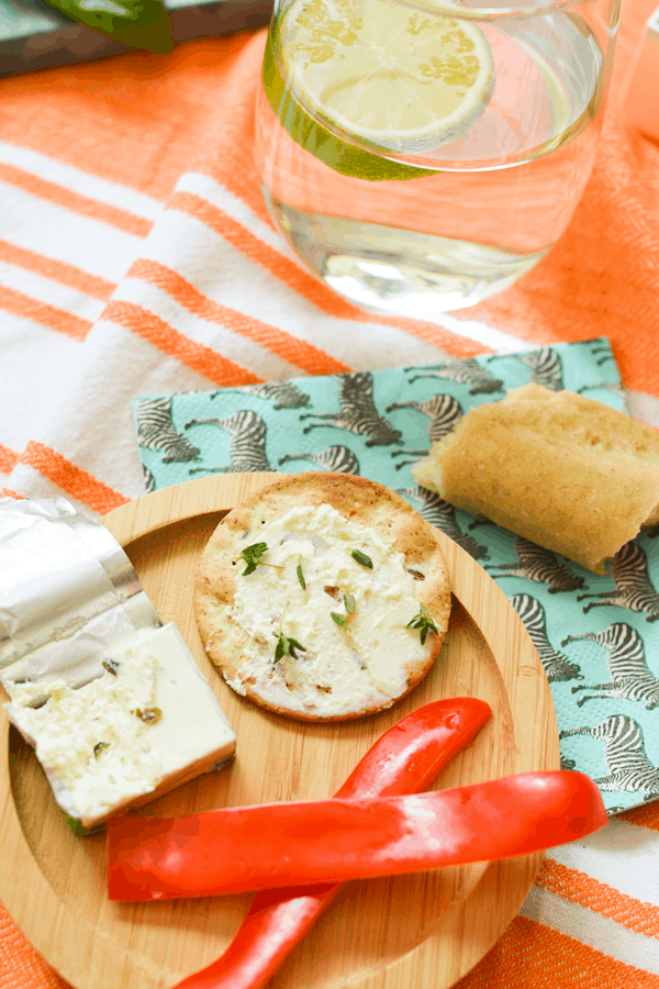 Cheese, bread, crackers and fresh vegetables for snacking.
