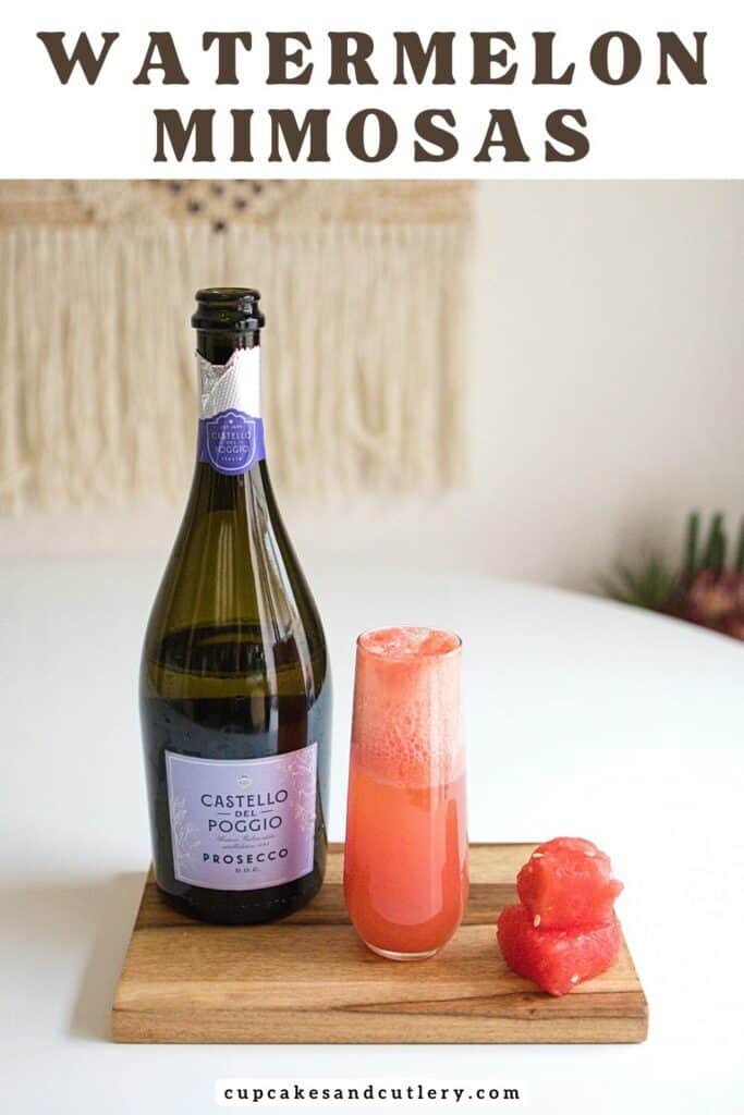 Text - Watermelon Mimosas with a bottle of champagne next to a stemless flute holding a watermelon mimosa.