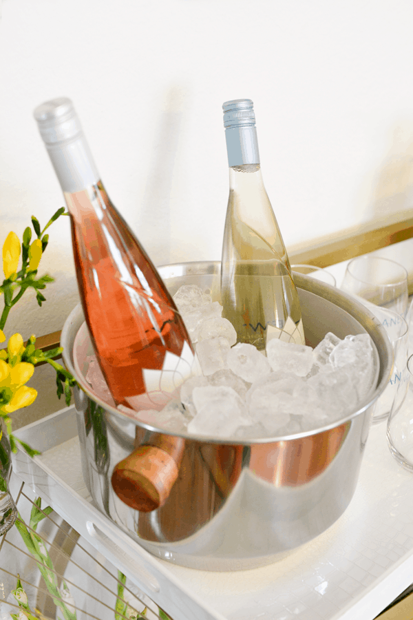 Rose and white wine in a wine bucket full of ice. 