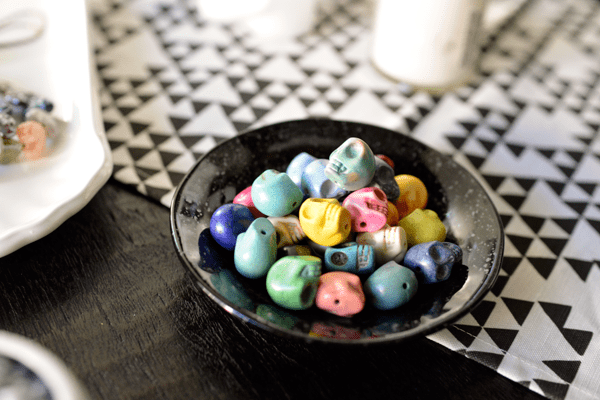 Use colorful skull shaped beads for a jewelry making activity at an adult Halloween party. 
