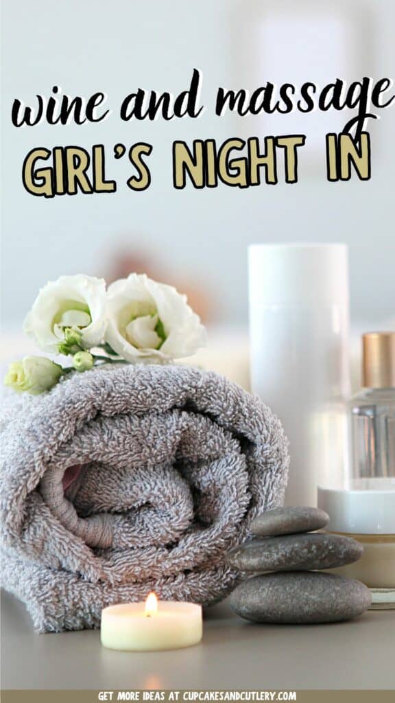 Text: Wine and Massage Girl's Night In with a towel rolled up next to candles and flowers.