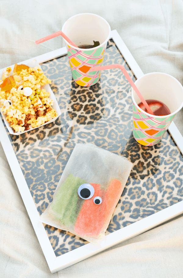 A food tray with snacks on top for an outdoor movie night. 