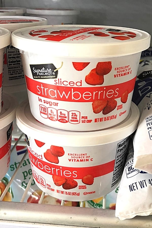 Frozen strawberries in the freezer section of the grocery store.