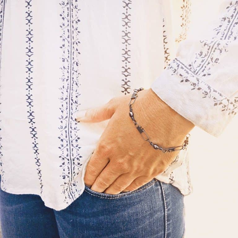 A woman wearing a snap swivel bracelet.