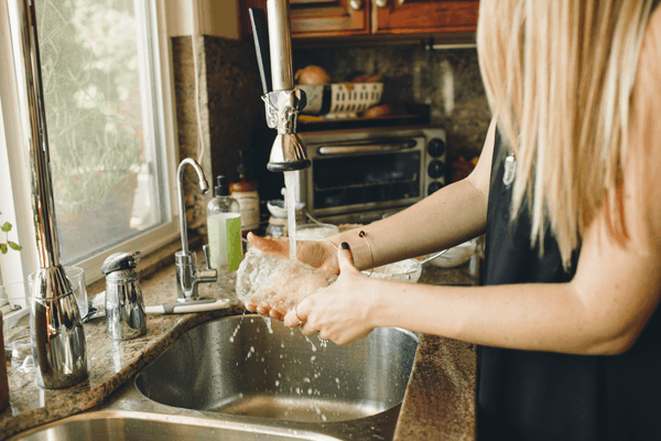 Turn down the water temperature when you wash dishes.