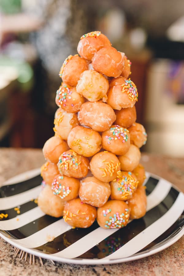 Close up of a donut hole tower with sprinkles. 