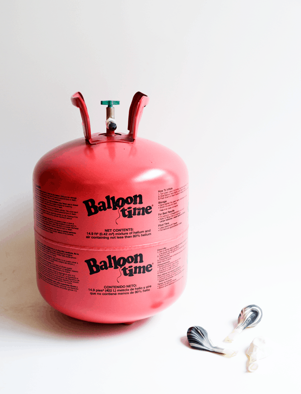 Close up of a pink helium tank for balloons. 