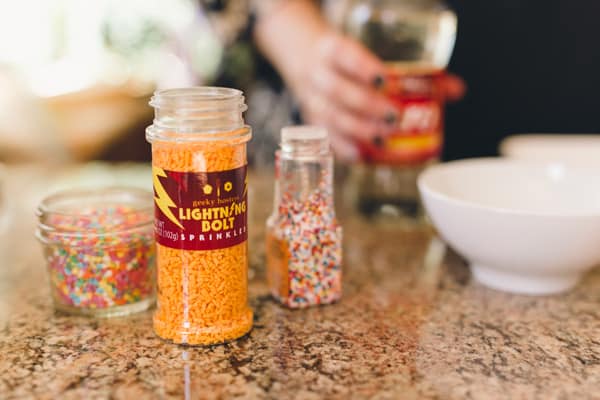Close up of sprinkle bottles on a counter.