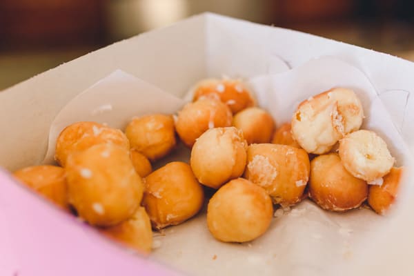 Close up of donut holes in a box. 
