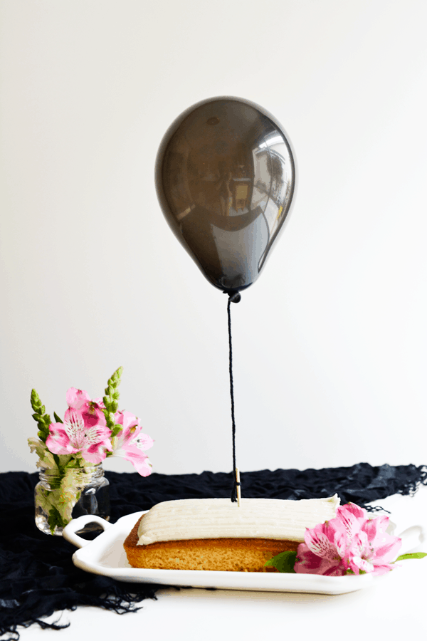 Use a balloon to top a birthday cake. It's a simple fun birthday ideas for boys and girls. 
