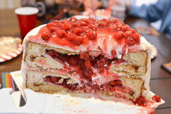 The inside of cherry pies baked into layers of vanilla cakes.