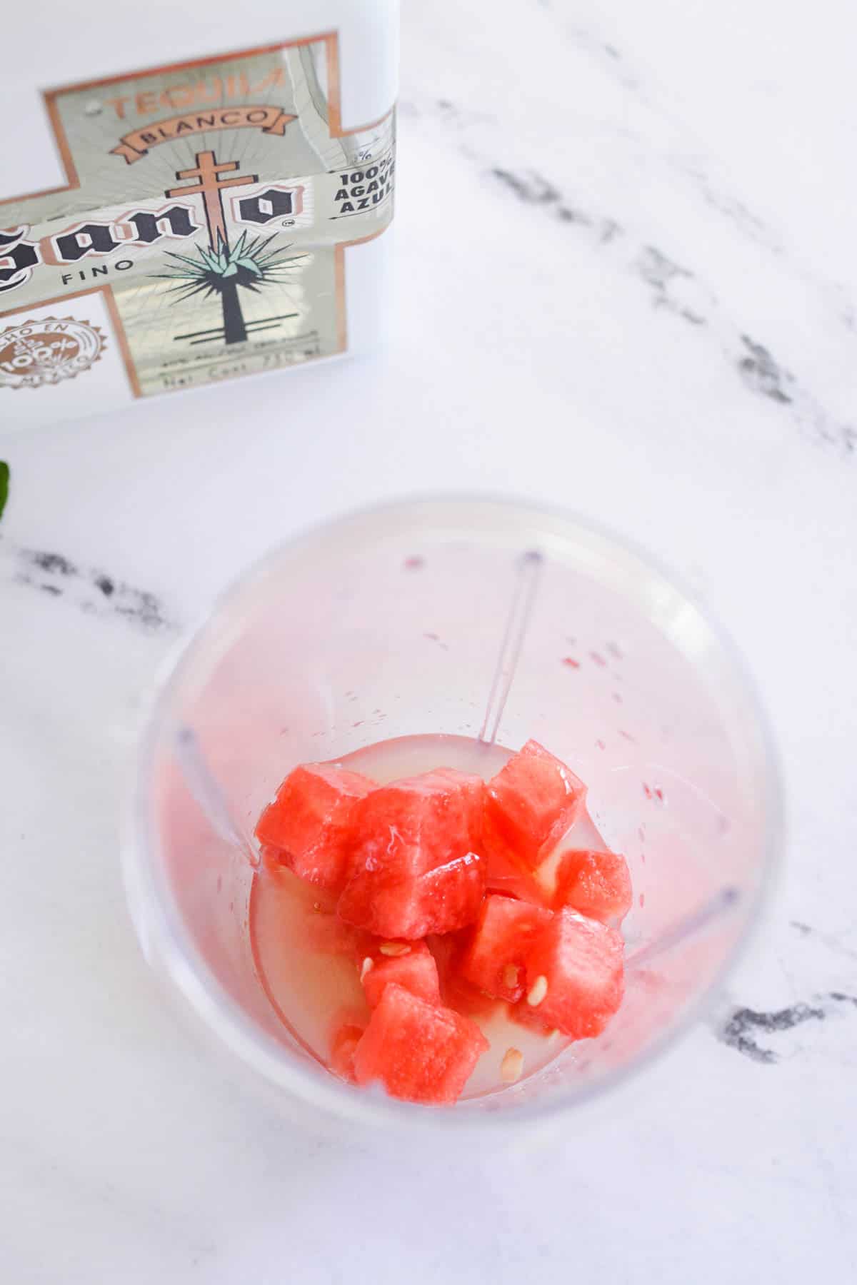 Fresh watermelon chunks in a blender cup.