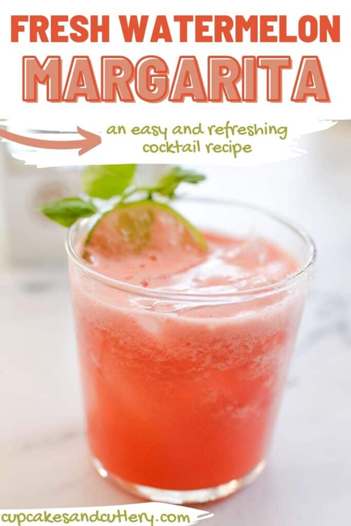 Close up of a fresh watermelon margarita in a glass with a mint garnish.