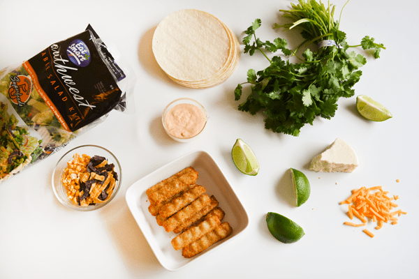 Ingredients to make fish stick tacos on a white countertop. 