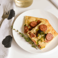 Try this yummy goat cheese pizza with bacon, Brussels Sprouts, sausage and parmesan. This flatbread pizza takes only a few minutes to put together and 8 minutes to bake!