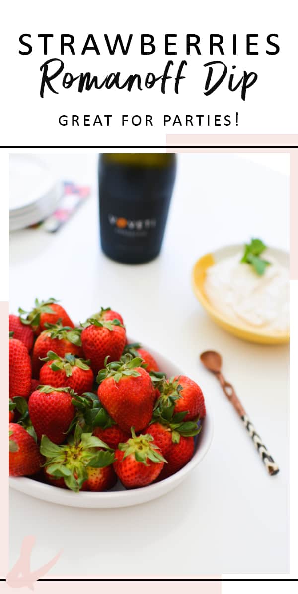 Bowl of strawberries on a table next to a bowl of Romanoff dip.