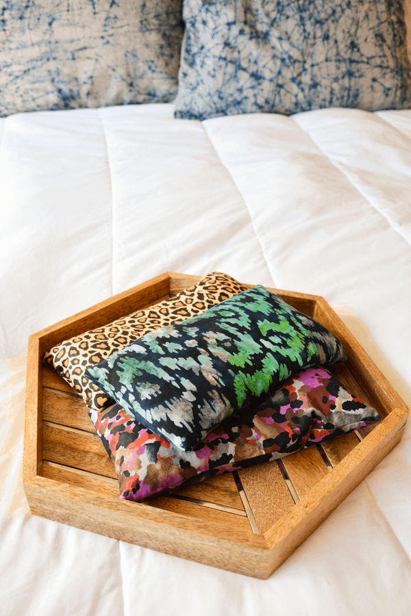 3 DIY freezer bags laying on top of each other on a wood tray.