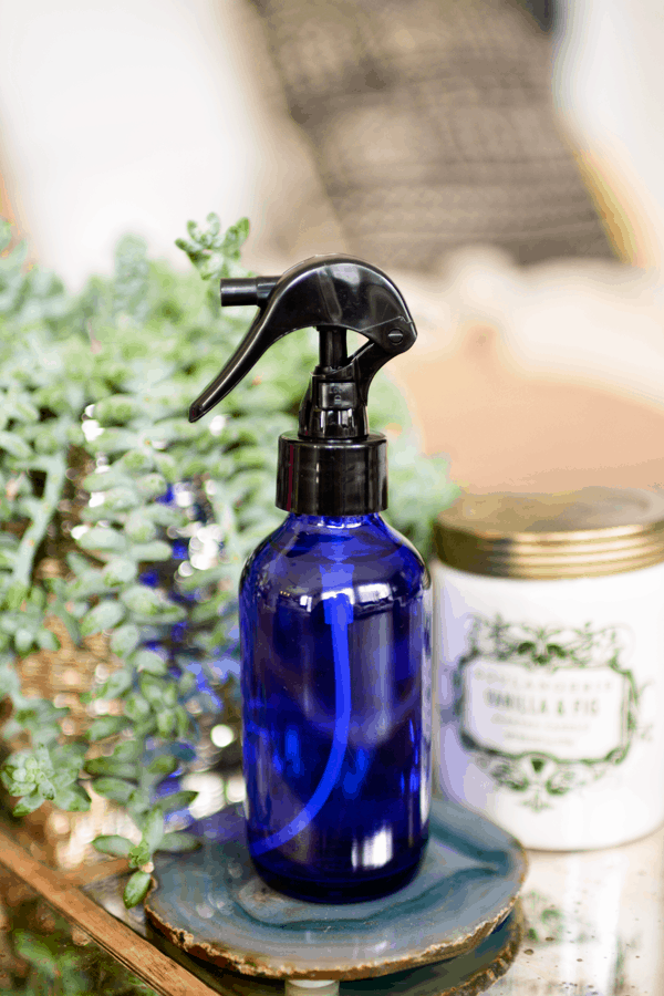 DIY room spray to promote good vibes in Cobalt Blue spray bottle.