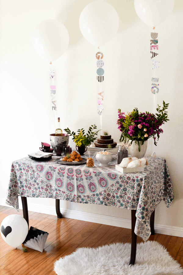 Good vibes themed baby shower. This boho shower is perfect with fresh flowers, air plants and a tapestry tablecloth