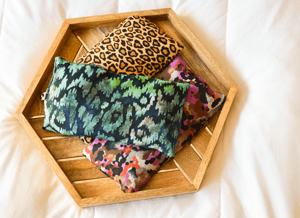 Top down view of headache relief bags on a wood tray.