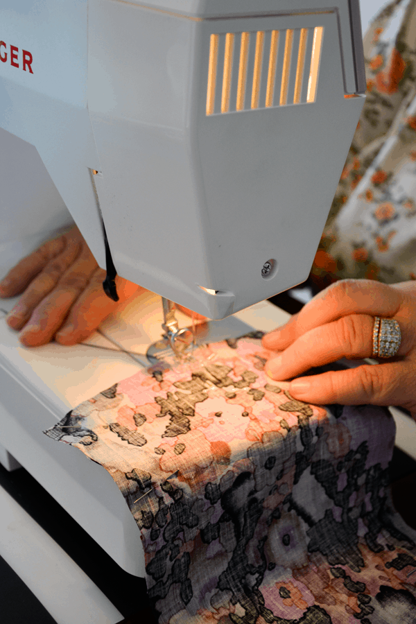 Woman using a sewing machine.