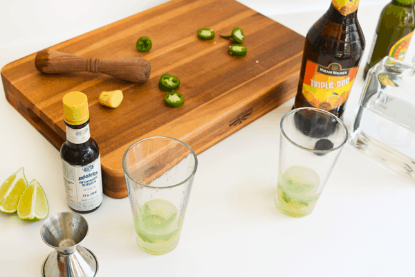 A counter with ingredients to make a spicy Mexican Mule cocktail. 