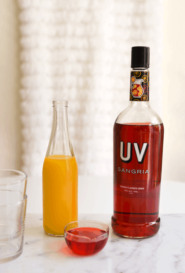 Ingredients needed to make a Vodka Sunrise cocktail. 