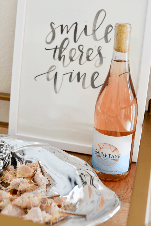 Sauvetage rose wine on a tray next to seashells. 