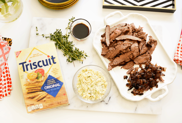 Ingredients on a counter to make Flank Steak Bites with blue cheese on top of triscuits. 