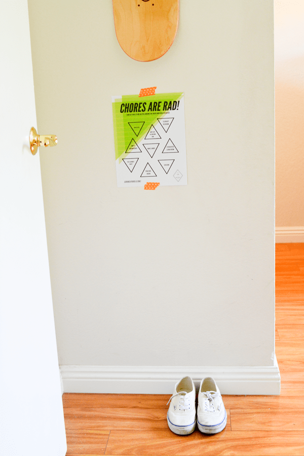 A free printable chore sheet taped to a bedroom wall. 