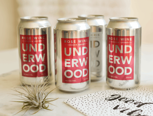 Canned rose wine on a table. 