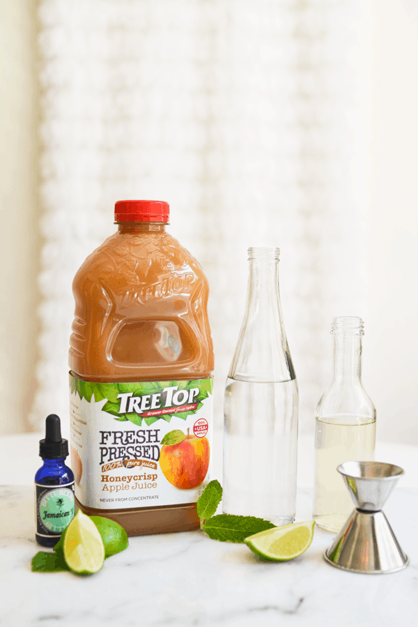 Ingredients to make a Mojito with apple juice on a table. 