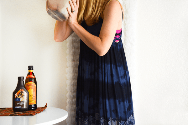 Woman drinking white russians out of a large milk jug. 