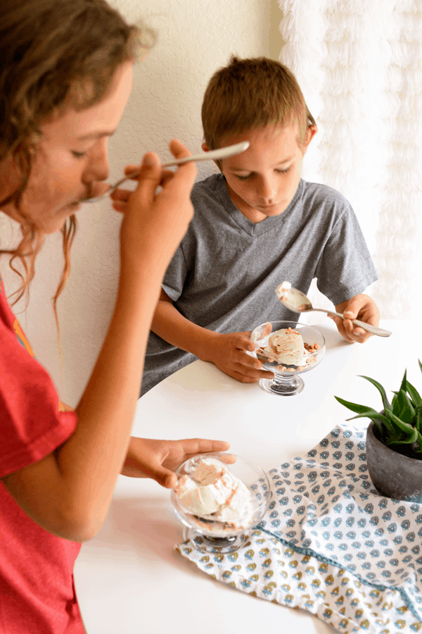 Two kids eating an easy dessert with fresh figs.