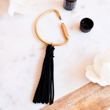 Keychain with a black tassel used for essential oils.