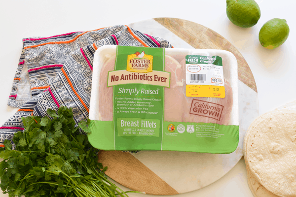 Close up of a package of Foster Farms chicken on a table. 